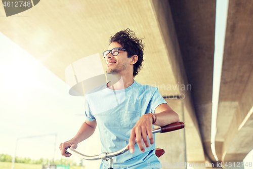 Image of young hipster man riding fixed gear bike