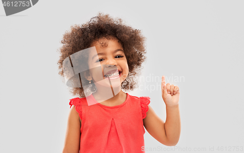 Image of little african american girl pointing finger up
