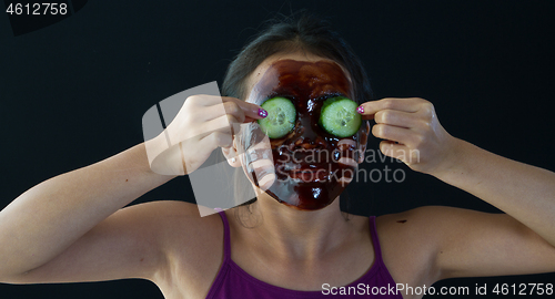 Image of young asian girl having fun with a chocolate mask