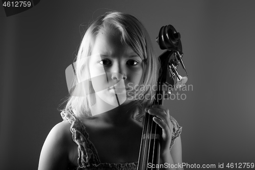 Image of Portrait of a young teenager girl in studio with a cello