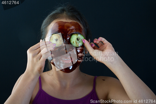 Image of young asian girl having fun with a chocolate mask