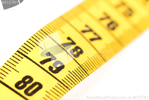 Image of Close-up of a yellow measuring tape isolated on white - 79