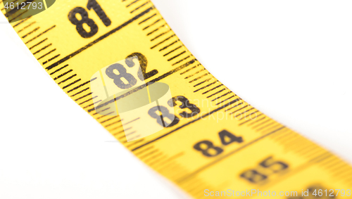 Image of Close-up of a yellow measuring tape isolated on white - 82