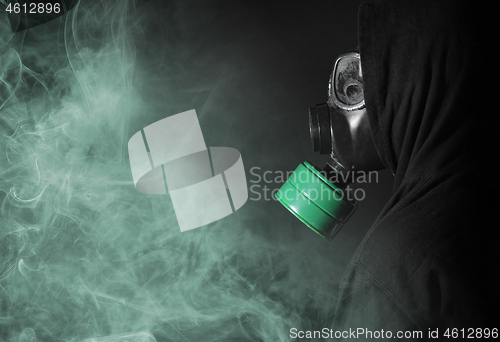 Image of Man in a gas mask in the smoke