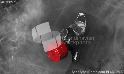 Image of Man in a gas mask in the smoke