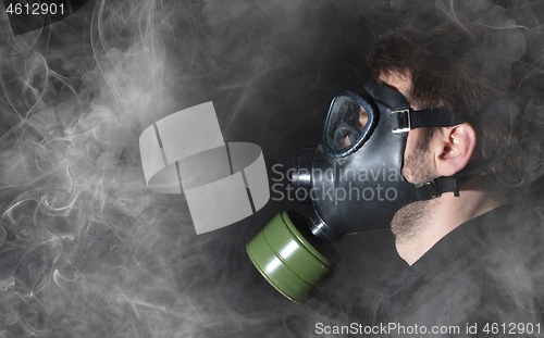 Image of Man in a gas mask in the smoke