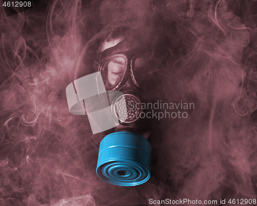 Image of Man in a gas mask in the smoke