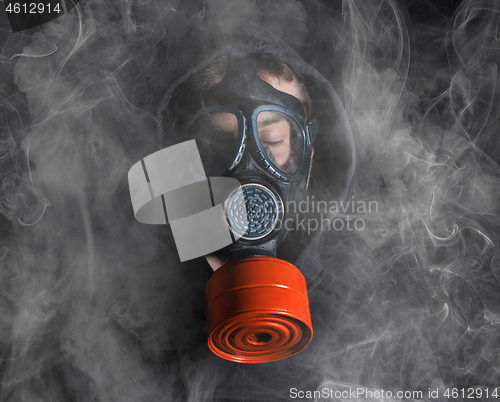 Image of Man in a gas mask in the smoke