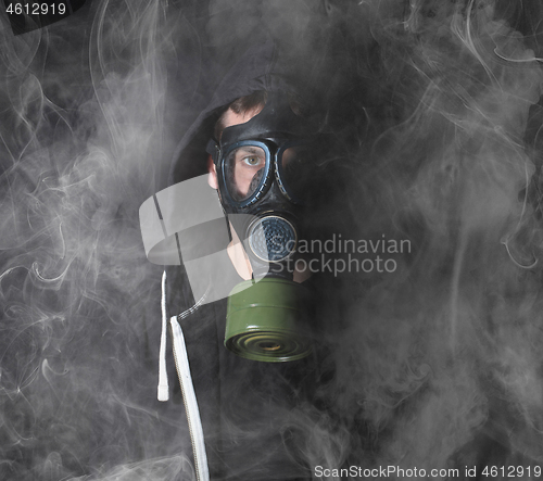 Image of Man in a gas mask in the smoke