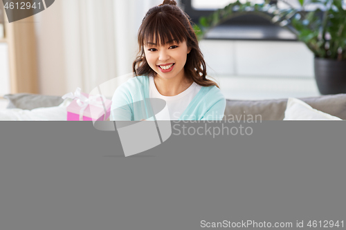 Image of asian female blogger with gift bag recording video