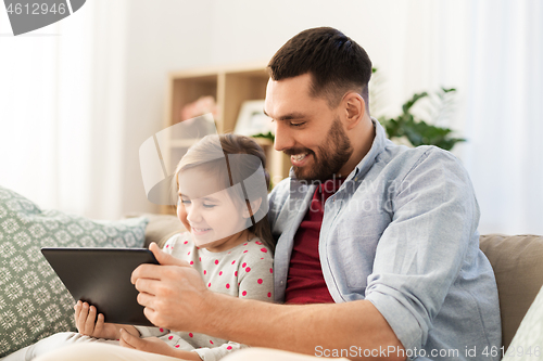 Image of father and daughter with tablet computer at home