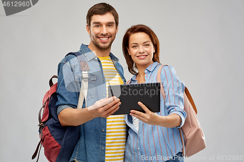 Image of happy couple of tourists with tablet computer