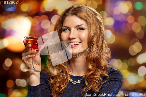 Image of woman with glass of cocktail at night club