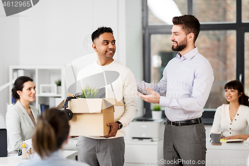 Image of new male employee meeting colleagues at office