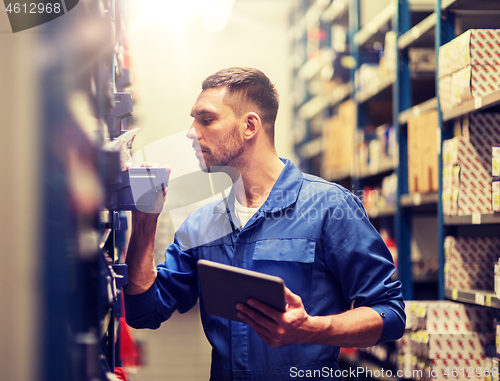 Image of auto mechanic or smith with tablet pc at workshop