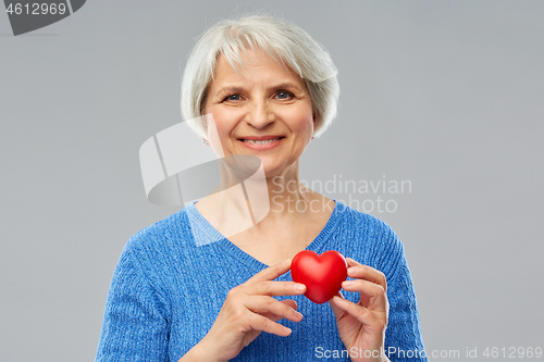 Image of smiling senior woman with red heart