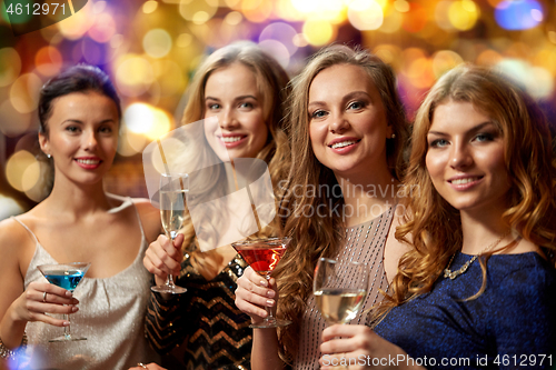 Image of happy women drinks in glasses at night club