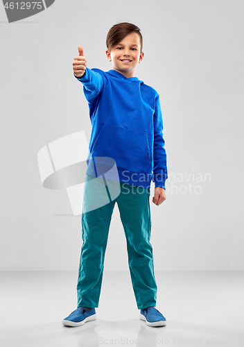 Image of smiling boy in blue hoodie showing thumbs up