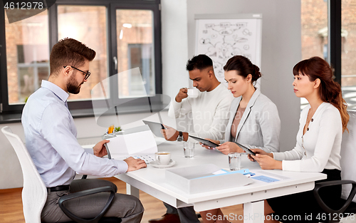 Image of recruiters having job interview with male employee