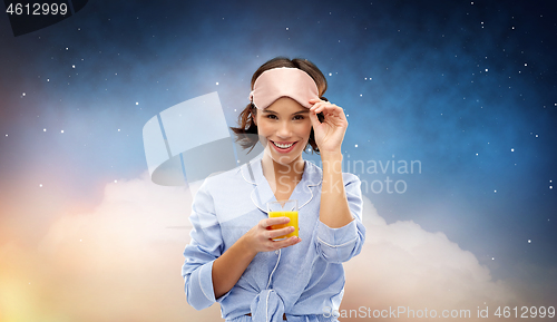 Image of woman in pajama and sleeping mask with juice