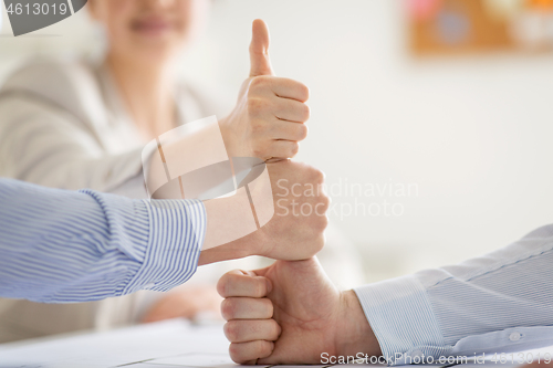 Image of group of business team making thumbs up gesture