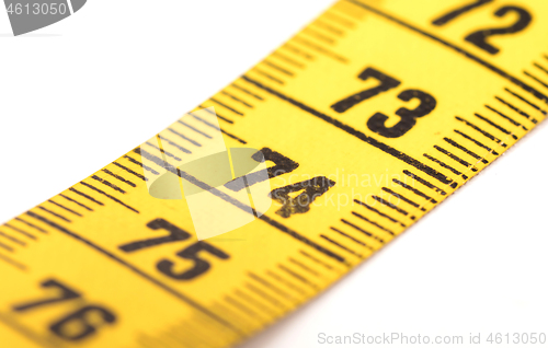 Image of Close-up of a yellow measuring tape isolated on white - 74