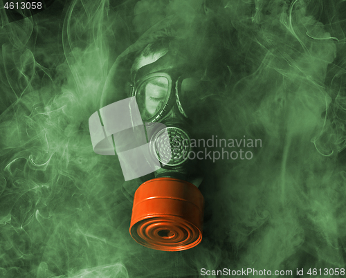 Image of Man in a gas mask in the smoke