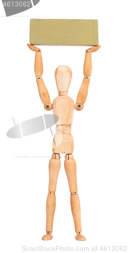 Image of Wooden mannequin carrying a wooden block