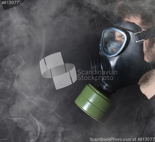 Image of Man in a gas mask in the smoke