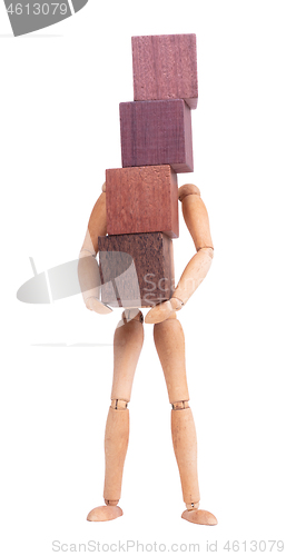 Image of Wooden mannequin carrying wooden hardwood blocks