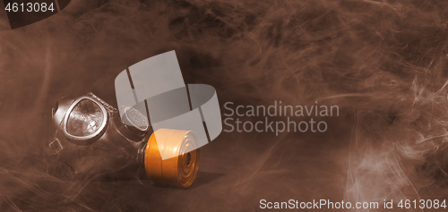 Image of Vintage gasmask isolated on black - Smoke in the room - Orange f