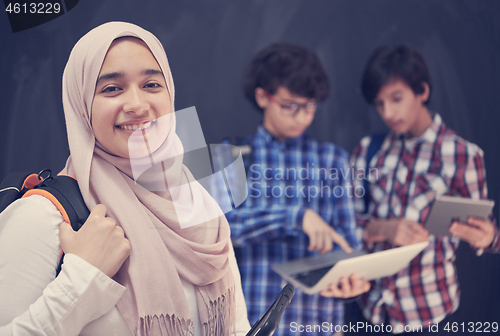 Image of Arab teenagers group working on laptop and tablet computer