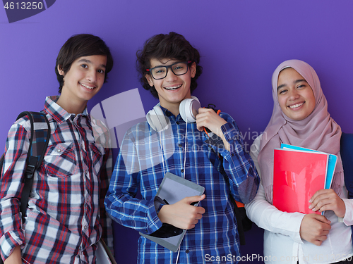 Image of Arab teenagers group working on laptop  computer together