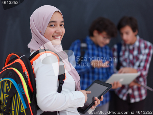 Image of Arab teenagers group working on laptop and tablet computer