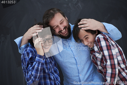 Image of happy father hugging sons