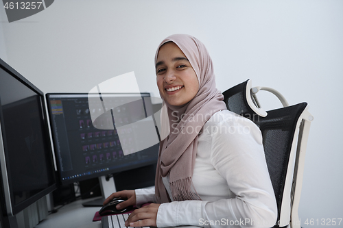 Image of Arabic creative professional  working at home office on desktop 