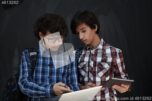 Image of Arab teenagers group working on laptop and tablet computer