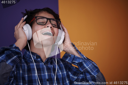 Image of Teenage Boy Wearing Headphones And Listening To Music