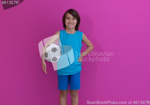 Image of Arabic boy with soccer ball against  pink background