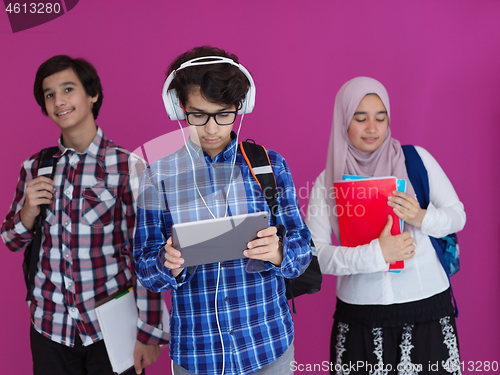 Image of Arab teenagers group working on laptop  computer together