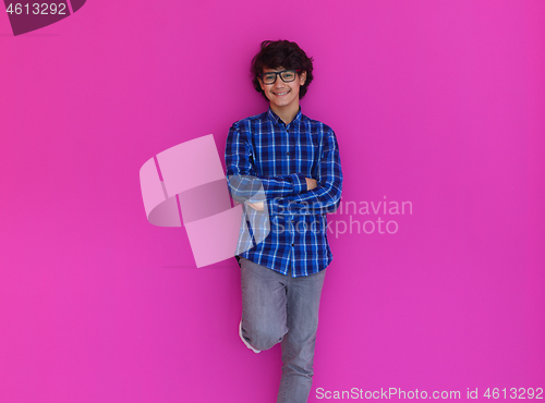 Image of portrait  of smart looking arab teenager  against pink backgroun