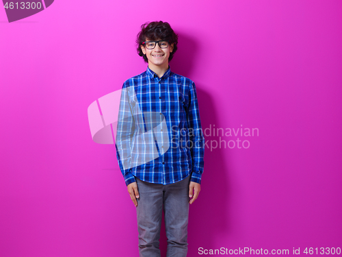 Image of portrait  of smart looking arab teenager  against pink backgroun