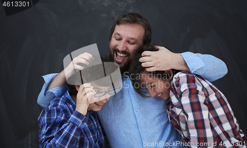 Image of happy father hugging sons