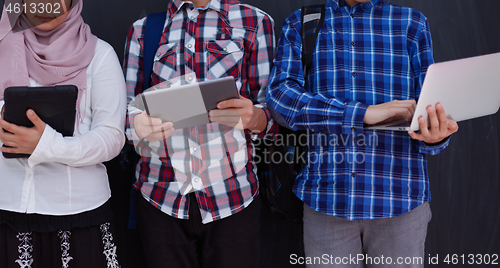 Image of Arab teenagers group working on laptop and tablet computer