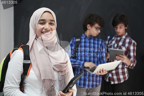 Image of Arab teenagers group working on laptop and tablet computer