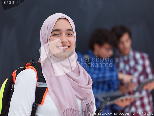 Image of Arab teenagers group working on laptop and tablet computer