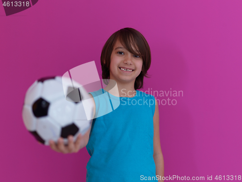 Image of Arabic boy with soccer ball against  pink background