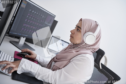 Image of Arabic creative professional  working at home office on desktop 