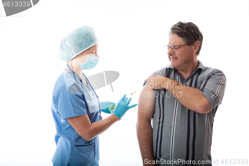 Image of A man receives the influenza vaccine by a treatment nurse