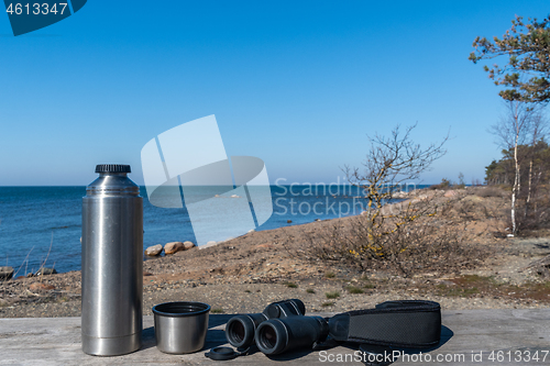 Image of Thermos and binoculars on a table